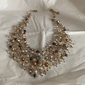 Crystal necklace with gold tone hardware and clasp.  The crystal’s vary in sizes